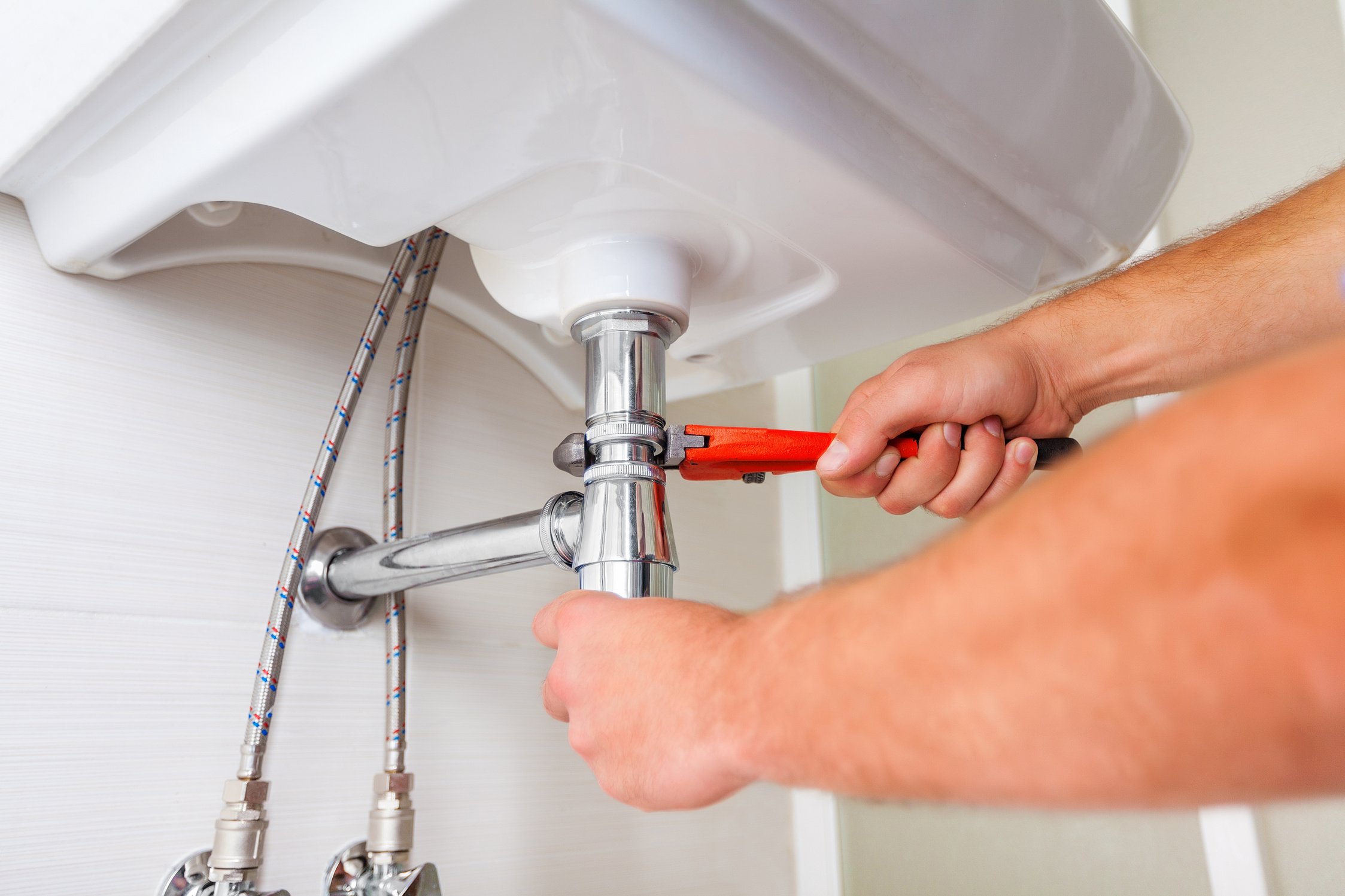 Plumber fixing a sink